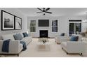 A spacious living room features neutral tones, plush seating, fireplace, and natural light streaming through large windows at 858 Lake Artesia Ln, Fuquay Varina, NC 27526
