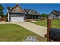 Spacious driveway leading to a charming home with a well-kept lawn and mailbox at 90 Pump Station Rd, Erwin, NC 28339