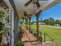 Relaxing covered porch with ceiling fans, rocking chairs, and views of the neighborhood at 90 Pump Station Rd, Erwin, NC 28339