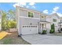 This two-story home boasts a garage, well-maintained lawn, and classic siding at 905 Moye Dr, Raleigh, NC 27606