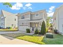 Beautiful two-story house featuring a covered front porch, garage, and green lawn at 905 Moye Dr, Raleigh, NC 27606