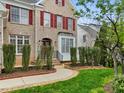 Elegant brick home featuring a decorative front entrance with arched doorway and manicured landscaping at 9220 Meadow Mist Ct, Raleigh, NC 27617