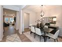 Elegant dining room featuring a modern chandelier, neutral walls, and seamless flow to other living spaces at 4867 Pioneer Dr, Sanford, NC 27330