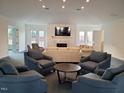 Comfortable community center living area featuring cozy seating and a fireplace with mounted TV at 100 Slippery Elm Rd, Youngsville, NC 27596