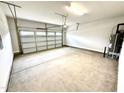 Spacious two car garage featuring concrete flooring and updated garage door at 107 Southern Estates Dr, Sanford, NC 27330