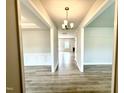 Hallway view showcases modern flooring, neutral paint, and recessed lighting, creating a welcoming and bright ambiance at 107 Southern Estates Dr, Sanford, NC 27330