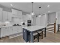 Modern kitchen featuring white cabinets, stainless steel appliances, and a spacious island with seating at 1136 Remey Ave, Wake Forest, NC 27587