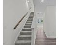 Hallway leading upstairs with hard floors and carpeted stairs for a modern touch at 1137 Solace Way, Rolesville, NC 27571
