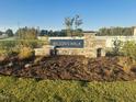 Stone-clad welcome sign for Wilson's Walk community, featuring lush landscaping and a serene setting at 133 N Keatts Winner Ct, Wilson's Mills, NC 27520