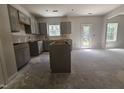 The new kitchen featuring sleek grey cabinets and an island, with ample space for customization at 143 Mildred Place, Broadway, NC 27505