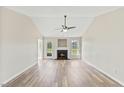 Bright living room with hardwood floors, fireplace, and neutral paint at 16 Monarch Trl, Selma, NC 27576