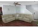 Inviting living room features a comfortable sectional sofa, ceiling fan, and gleaming hardwood floors at 1613 Beacon Valley Dr, Raleigh, NC 27604