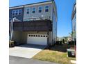 View of a two-car garage with an upper deck, offering convenient parking and outdoor space at 1643 Wimberly Rd, Apex, NC 27523