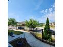 Inviting neighborhood scene with sidewalks and manicured lawns and black metal fence at 1643 Wimberly Rd, Apex, NC 27523