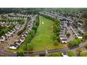 Scenic aerial view of a neighborhood surrounding a lush green golf course, showcasing community living at 2120 Castle Pines Dr, Raleigh, NC 27604