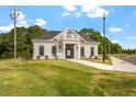 Exterior view of a clubhouse with classic architectural details, and manicured landscaping at 230 N Maple Walk Dr # 230, Garner, NC 27529