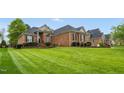 Beautiful brick home featuring a manicured lawn and lovely landscaping, creating great curb appeal at 2326 Marlow Dr, Burlington, NC 27215