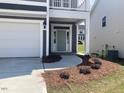 Home features a covered front entryway with gray siding and a light gray door at 245 N Maple Walk Dr # 219, Garner, NC 27529