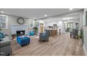 Open-concept living area featuring a stone fireplace, modern furnishings, and seamless flow to the kitchen at 3014 Hope Valley Rd, Durham, NC 27707
