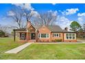 Beautiful brick home with a welcoming front porch, well-kept lawn, and a traditional design at 305 E First St, Princeton, NC 27569