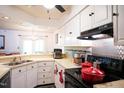 The kitchen features lots of white cabinets, modern appliances, and tile backsplash at 3336 Tarleton W, Durham, NC 27713