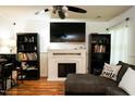 Comfortable living room with white fireplace and ceiling fan at 3336 Tarleton W, Durham, NC 27713