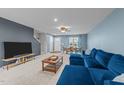 Spacious living room with comfortable seating, neutral carpet, and a view into the adjacent dining area at 4524 Flat Bastion Drive Dr, Raleigh, NC 27610