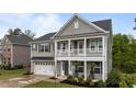 Charming two-story home with a welcoming front porch and a two-car garage, showcasing classic architectural details at 4803 Stony Falls Way, Knightdale, NC 27545