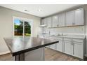 Open kitchen featuring granite countertops, tile backsplash, ample natural light, and wood-look flooring at 500 John St St, Clayton, NC 27520