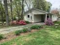 Charming home exterior showcasing covered parking, well maintained landscaping, and blossoming azaleas at 505 E Graham St, Mebane, NC 27302