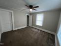 Bedroom features neutral carpet, ceiling fan, and a closet at 5116 Nc 56 Hwy, Franklinton, NC 27525