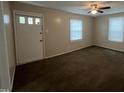 Cozy living room featuring neutral carpet, blinds, and a ceiling fan at 5116 Nc 56 Hwy, Franklinton, NC 27525