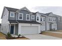 Stylish two-story townhome with a two-car garage, modern exterior, and well-maintained landscaping at 540 Eversden Dr, Zebulon, NC 27597