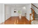 This living room features hardwood floors and decorative molding and is conveniently located near the stairway at 5507 Vista View Ct, Raleigh, NC 27612