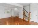 Open-concept living room with hardwood floors and staircase at 5507 Vista View Ct, Raleigh, NC 27612