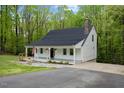 View of house showcasing the covered porch, driveway and well maintained lawn at 5541 Old Still Rd, Wake Forest, NC 27587