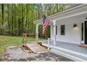 Inviting covered front porch with stone walkway and access ramp at 5541 Old Still Rd, Wake Forest, NC 27587