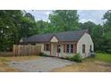 Exterior view of a charming tan duplex with red shutters and a gravel front yard at 56 Marlless Dr # A & B, Franklinton, NC 27525