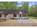 A well-maintained single-story home with red shutters, wood accents, and a gravel front yard at 56 Marlless Dr # A & B, Franklinton, NC 27525