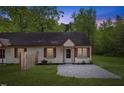 Exterior of a cute duplex with a gravel front yard and wood privacy fence at 56 Marlless Dr # A & B, Franklinton, NC 27525