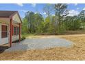 Side angle view of a light colored house with gravel and natural landscaping at 56 Marlless Dr # A & B, Franklinton, NC 27525