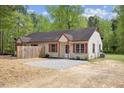 Exterior of charming duplex with a gravel parking area, red shutters, and mature trees at 56 Marlless Dr # A & B, Franklinton, NC 27525