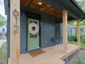 Inviting front porch with wood columns, comfortable seating, and a decorative wreath on the door at 612 E Ellerbee St, Durham, NC 27704