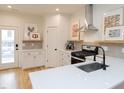 Modern kitchen features sleek countertops, stainless steel appliances, a black faucet, and stylish decor at 612 E Ellerbee St, Durham, NC 27704