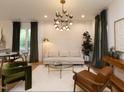 Bright living room featuring hardwood floors, modern lighting fixture, and comfortable contemporary furnishings at 612 E Ellerbee St, Durham, NC 27704