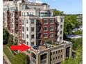 Luxurious condo rooftop terrace with modern furniture, plants, and pergola, perfect for entertaining at 618 N Boylan Ave # 304, Raleigh, NC 27603