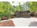 Charming two-story home with a spacious driveway surrounded by mature trees and landscaped grounds at 635 Kensington Dr, Chapel Hill, NC 27514
