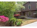 Landscaped front yard with mature plantings leading to the inviting front porch and entry at 635 Kensington Dr, Chapel Hill, NC 27514