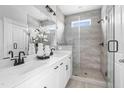 Bright bathroom featuring a double vanity, neutral paint and a glass enclosed shower with gray tiling at 668 Bandon Aly, Cary, NC 27513
