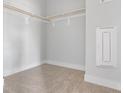 A bright and airy walk-in closet space with carpeting, a hanging rack and white walls at 668 Bandon Aly, Cary, NC 27513